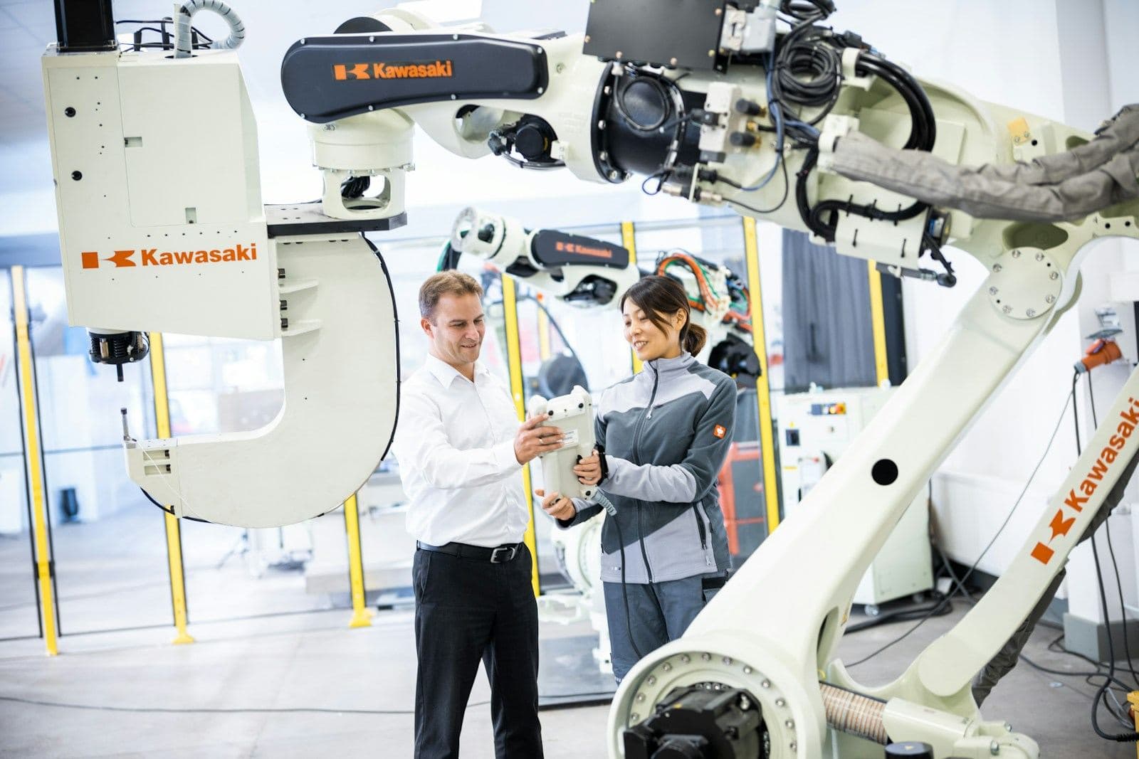 Engineers reviewing an automated robot cell