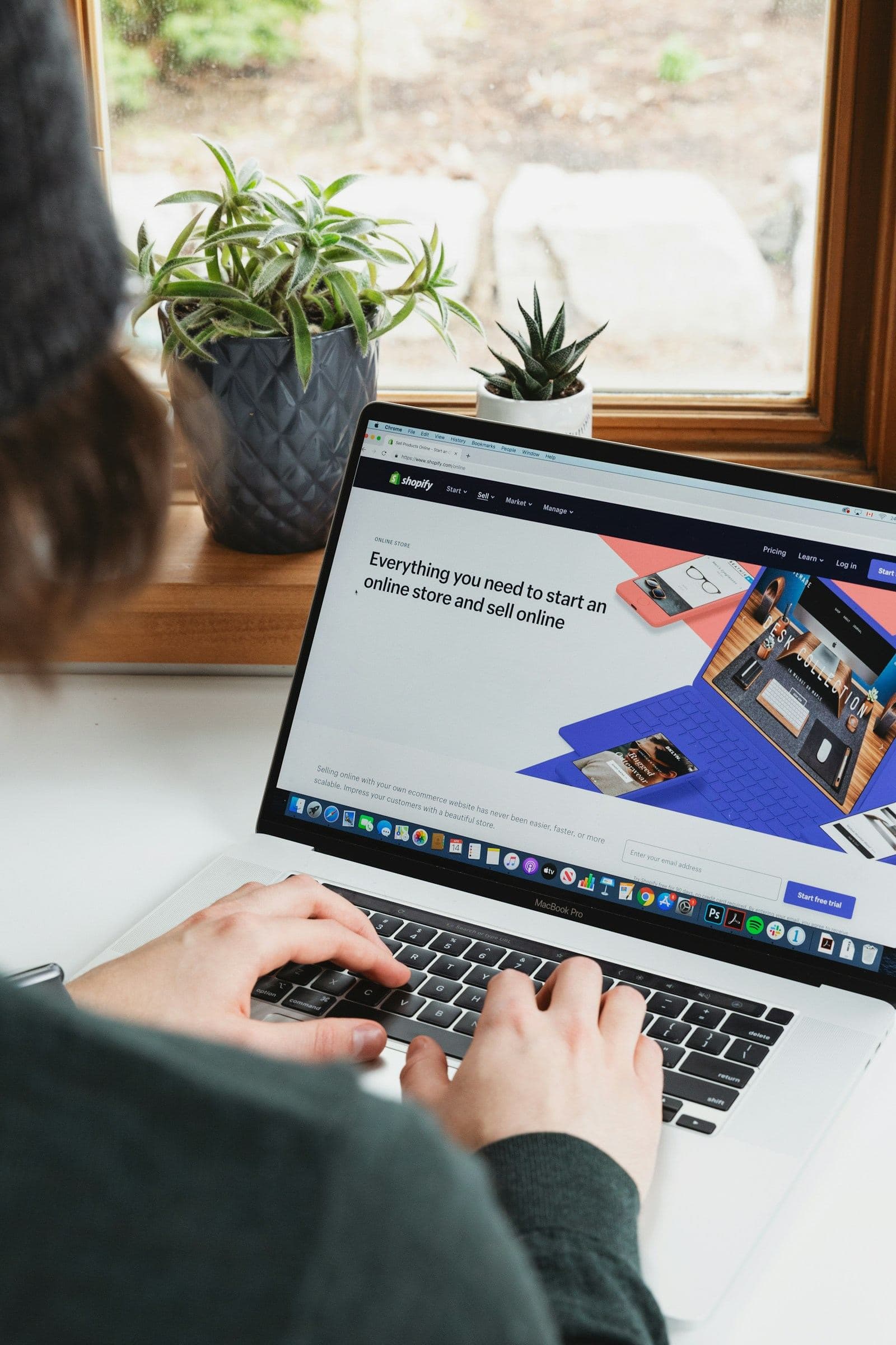 Person setting up an online store on a laptop