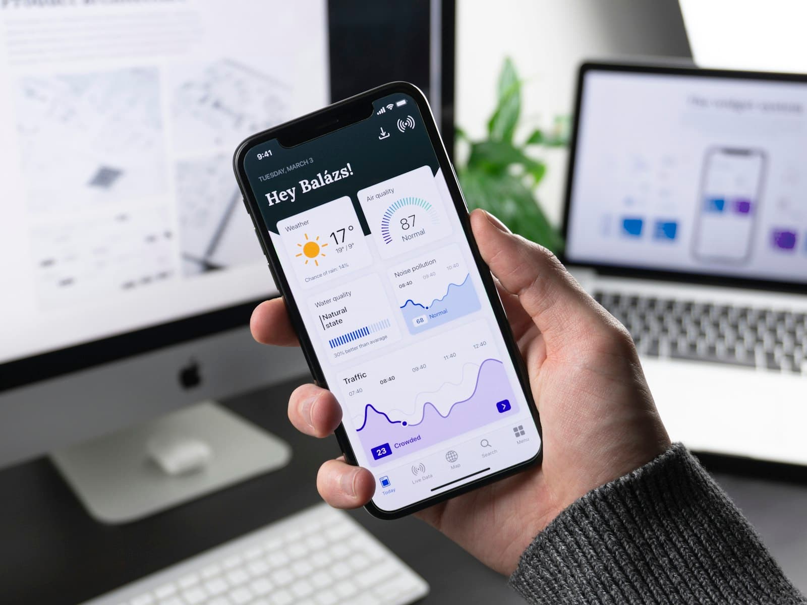 Hand holding a phone with a dashboard app