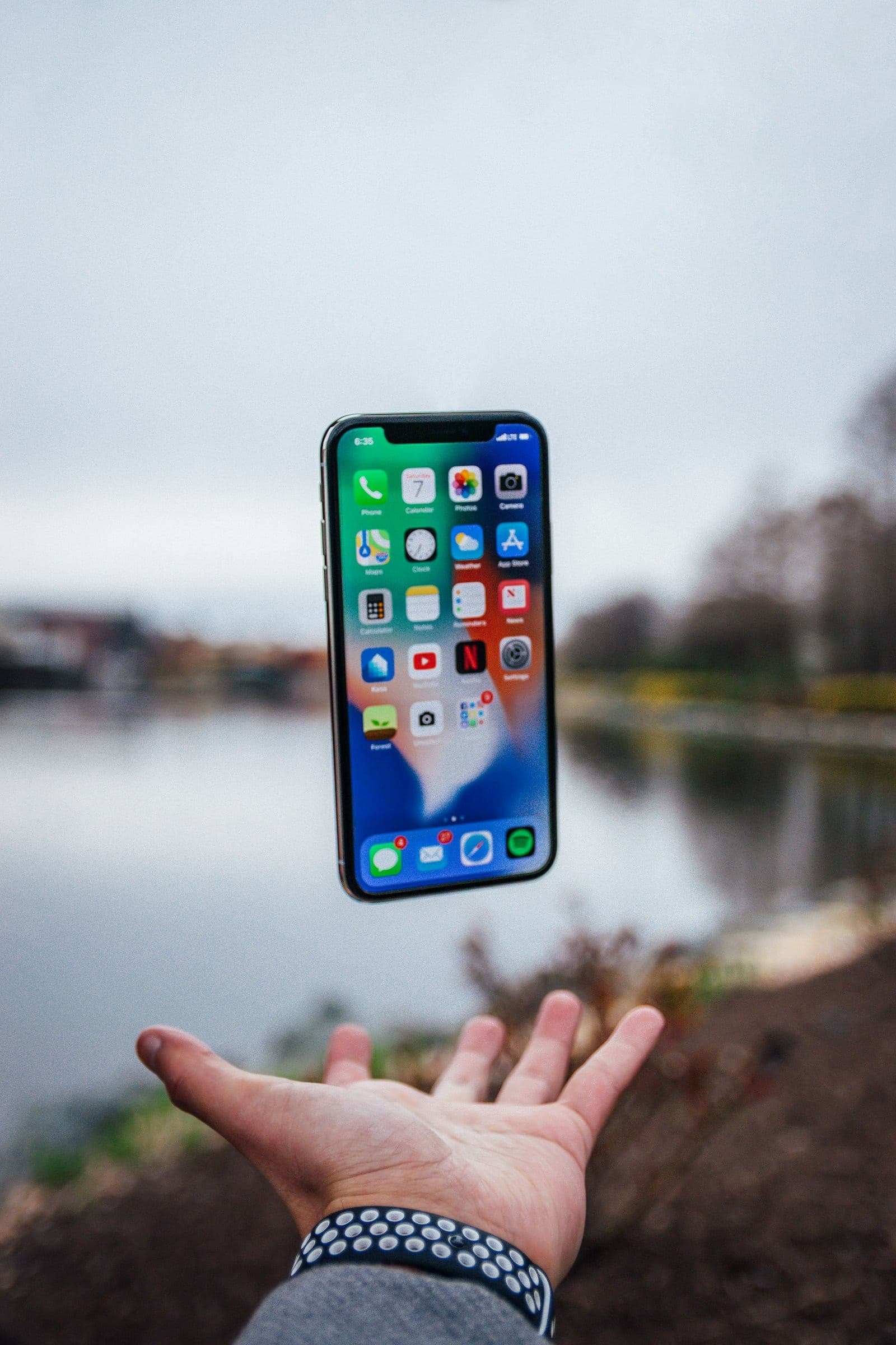 Phone floating above an open hand