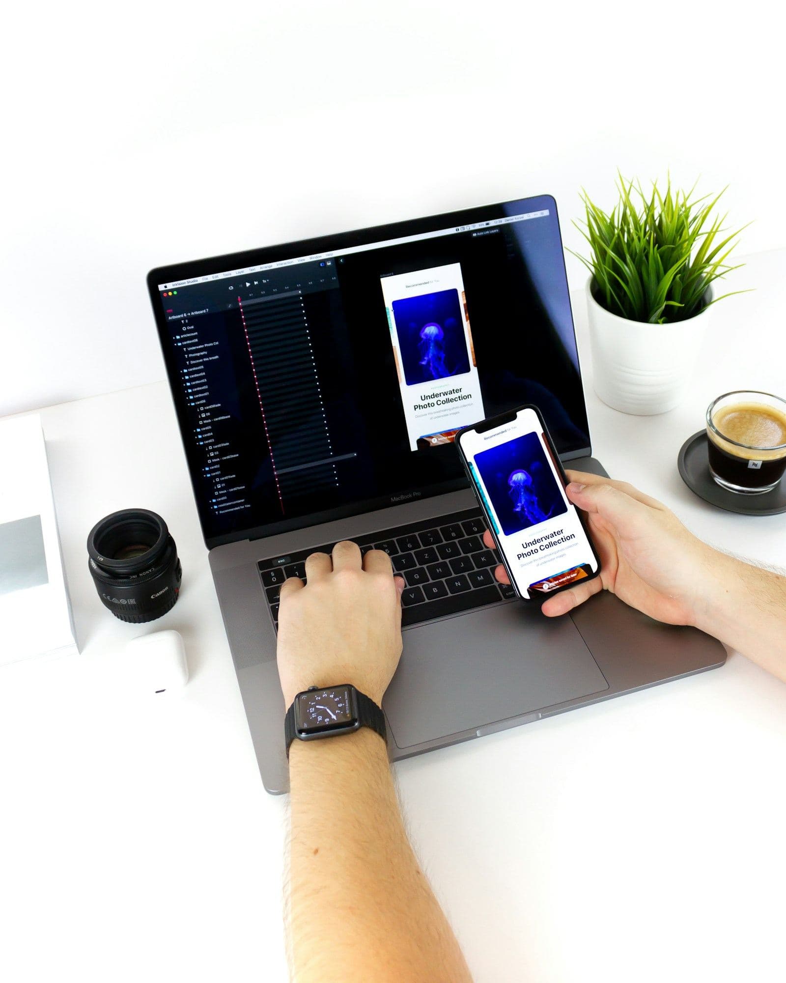 Developer testing a mobile build beside a laptop