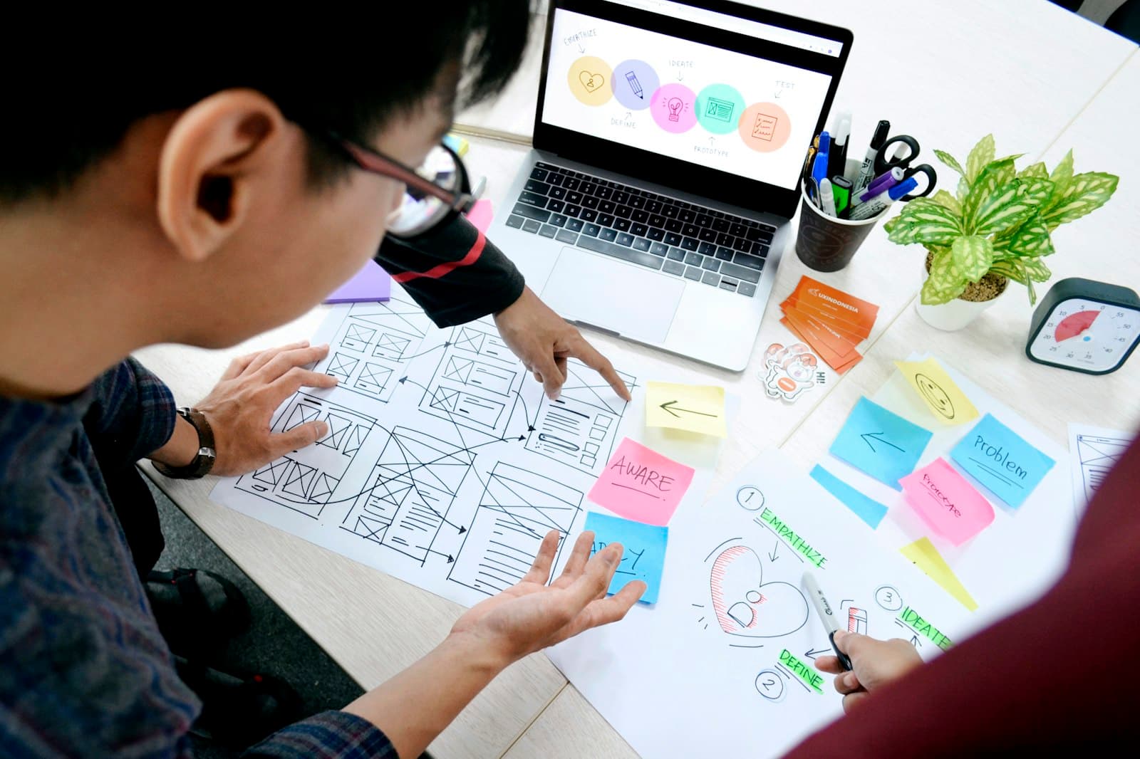 Designer working on wireframes at a desk