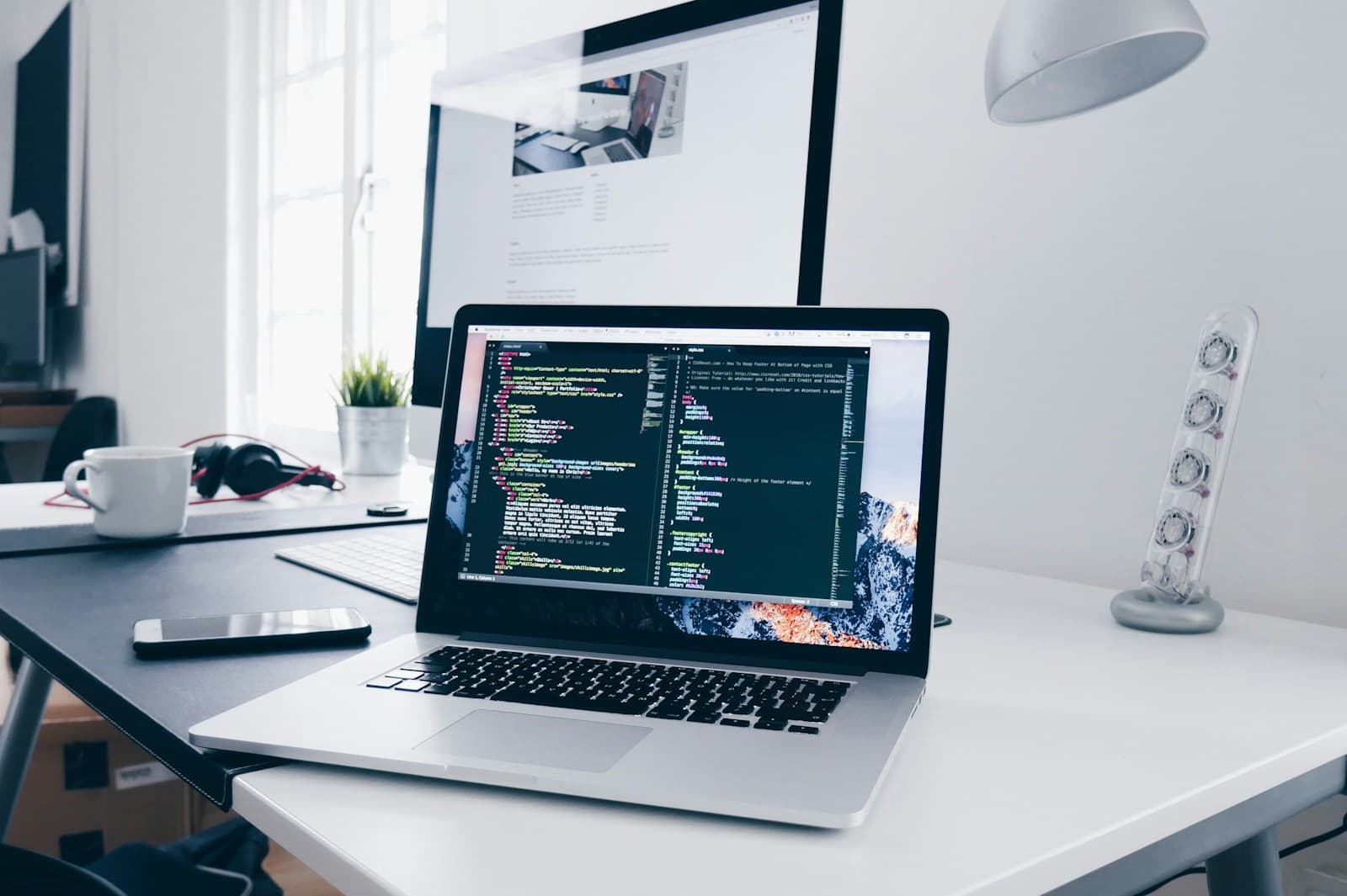 Laptop with code on a developer desk